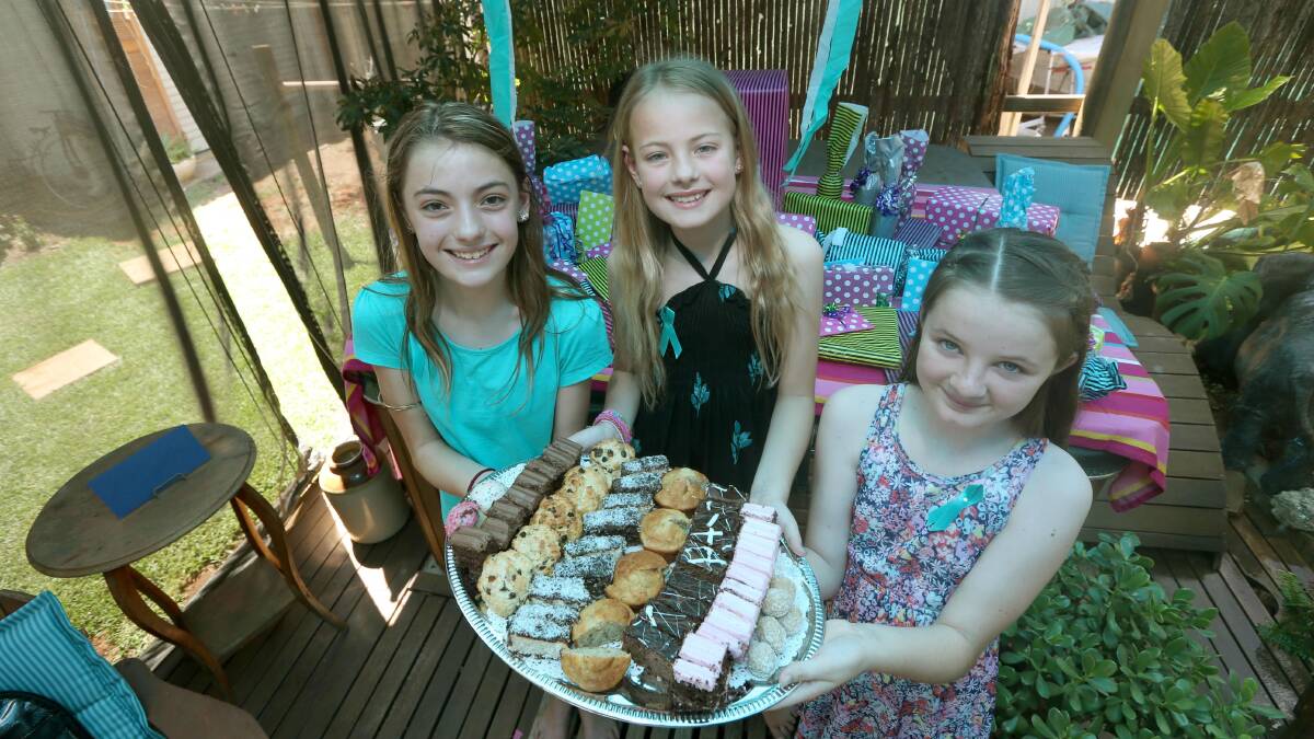SWEET APPROACH: Brittney Taylor, 13, her sister Elyse, 11, and friend Fallon Millis, 11, serve up delicious fare on Saturday to raise awareness and funds for Ovarian Cancer Australia. Picture: Anthony Stipo.