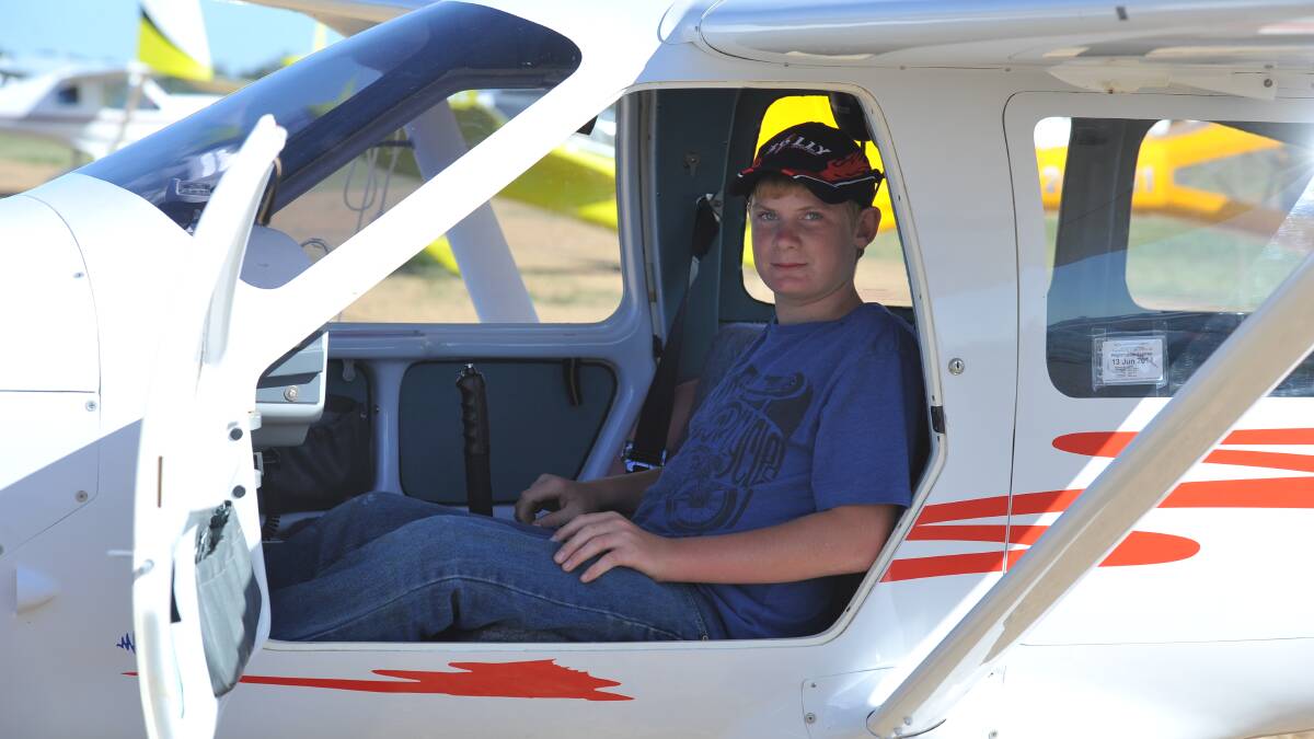 TEMORA: Nicholas Madden gets a feel for one of the aircraft during the annual Easter fly-in at the Temora Aviation Museum. Picture: Laura Hardwick, The Daily Advertiser 