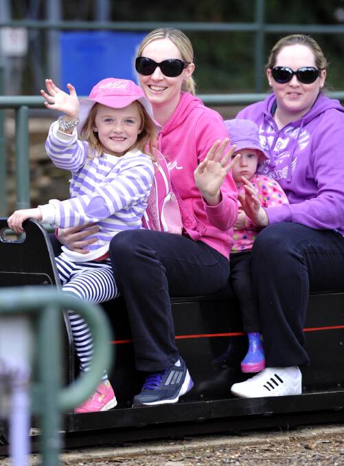 WAGGA: Brianna Elphick, 6, (left) Megan Elphick and Kacey Elphick, 2, all from Wagga, enjoy the Willans Hill Miniature Railway with the kids' aunt Lisa Scoullar, of Batlow. The railway hosted a 12-hour ride-a-thon on Sunday. Picture: Les Smith, The Daily Advertiser