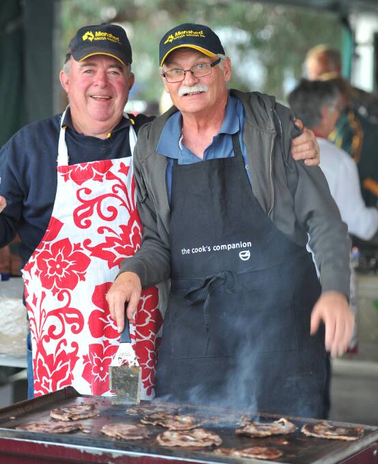 WAGGA: Peter Quinane (left) and John Killalea from the Wagga's Men's Shed at work on the BBQ to feed the hungry crowds at the Stone the Crows Festival. Picture: Kieren L Tilly, The Daily Advertiser