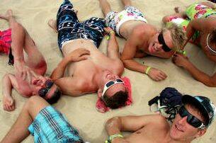 Last year's Schoolies Week revellers enjoy the sunshine of the Gold Coast.  Photo: Sun Herald, Michelle Smith. Clockwise from left: Jack Castle, Michael Dillon, William Neville, James Curnow and Brodie Thomson, all from Kyabram, Victoria.