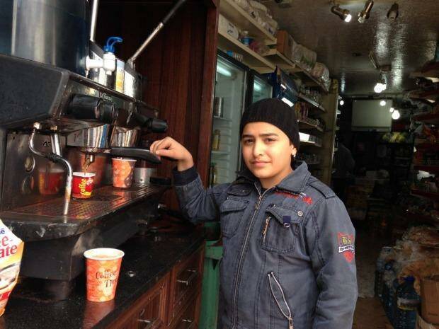 Syrian refugee Mohamed makes coffee in a Lebanese cafe to support his family of seven. Photo: Ruth Pollard