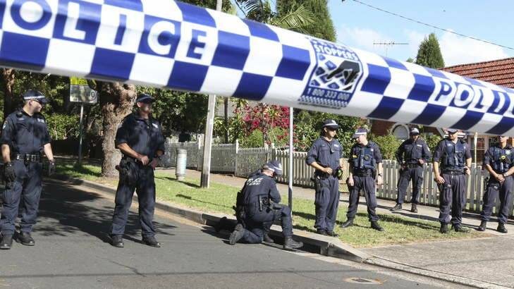 Police at the scene: a man was shot dead in front of his family. Photo: Peter Rae