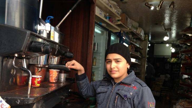 Syrian refugee Mohamed makes coffee in a Lebanese cafe to support his family of seven. Photo: Ruth Pollard