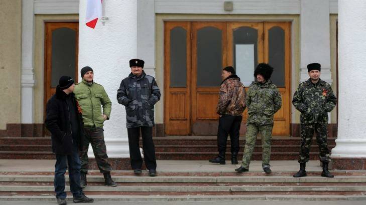Pro-Russian “self-defence” forces and Cossacks  in front of a building that joins the control tower at Simferopol airport. Photo: Kate Geraghty