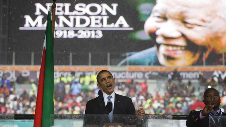 "He changed laws, but he also changed hearts" ... President Barack Obama speaks to crowds attending the memorial service for former South African president Nelson Mandela at the FNB Stadium. Photo: AP Photo