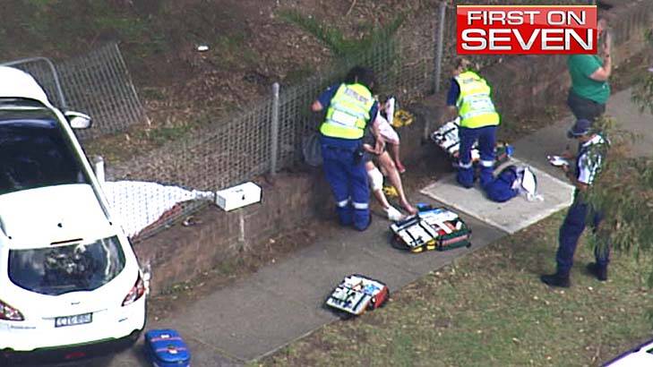 Tragedy: a person is treated after the crash outside Carlingford Public School. Photo: Seven News