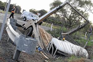 OUT OF CONTROL: A truck carrying a load of skip bins ended up in the canal after the driver failed to give way at the Thorne Road and Murrumbidgee Avenue intersection and collided with a station wagon on Wednesday afternoon. Inset: The L-plate driver, just three days past his 16th birthday, managed to save his mother and young sister from serious injury.