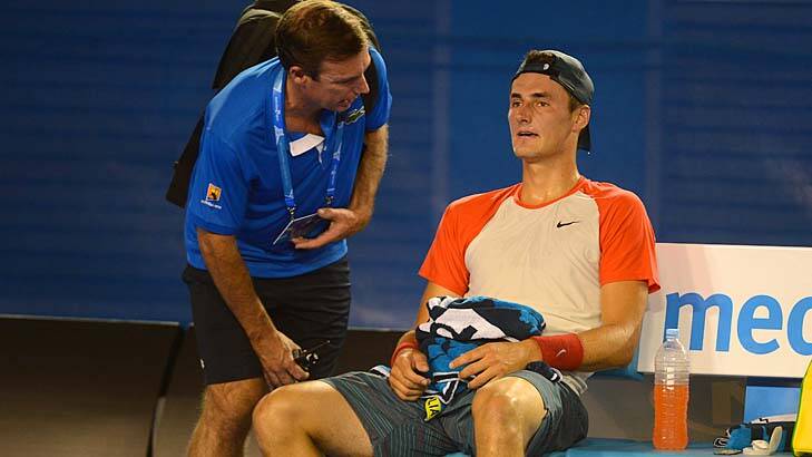 Bernard Tomic speaks to the doctor during his match against Rafael Nadal. Photo: Pat Scala