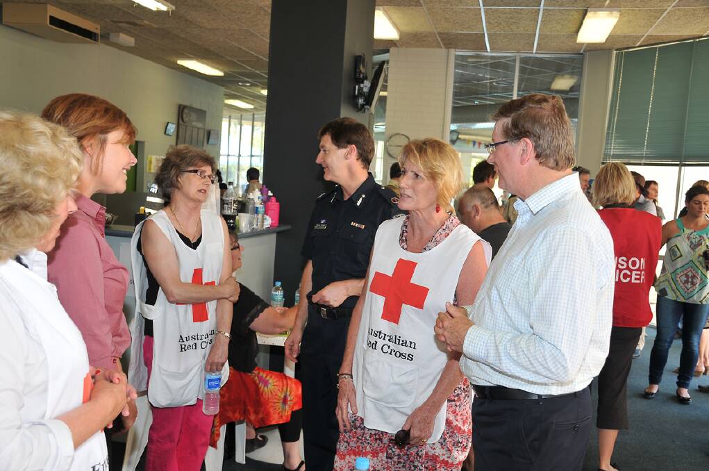 The Victorian Premier Denis Napthine meets with volunteers and people displaced at the relief centre at the Stawell Leisure Complex. Pictures: MARK McMILLAN.