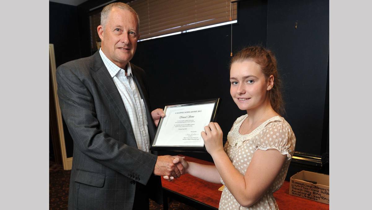 University student Sinead Stone (right) is presented with a Gallipoli Scholarship by RSL and Services Club Association CEO Graeme Carroll. Photo: Michael Frogley
