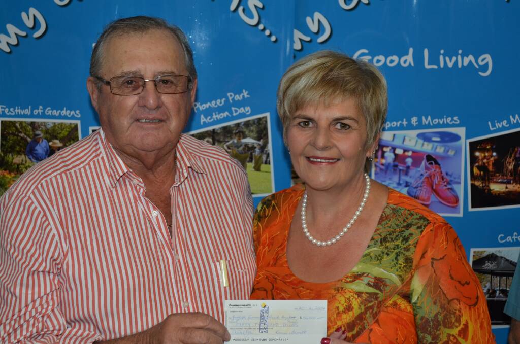 Mayor John Dal Broi accepts a cheque for $50,000 from Denise Bennett