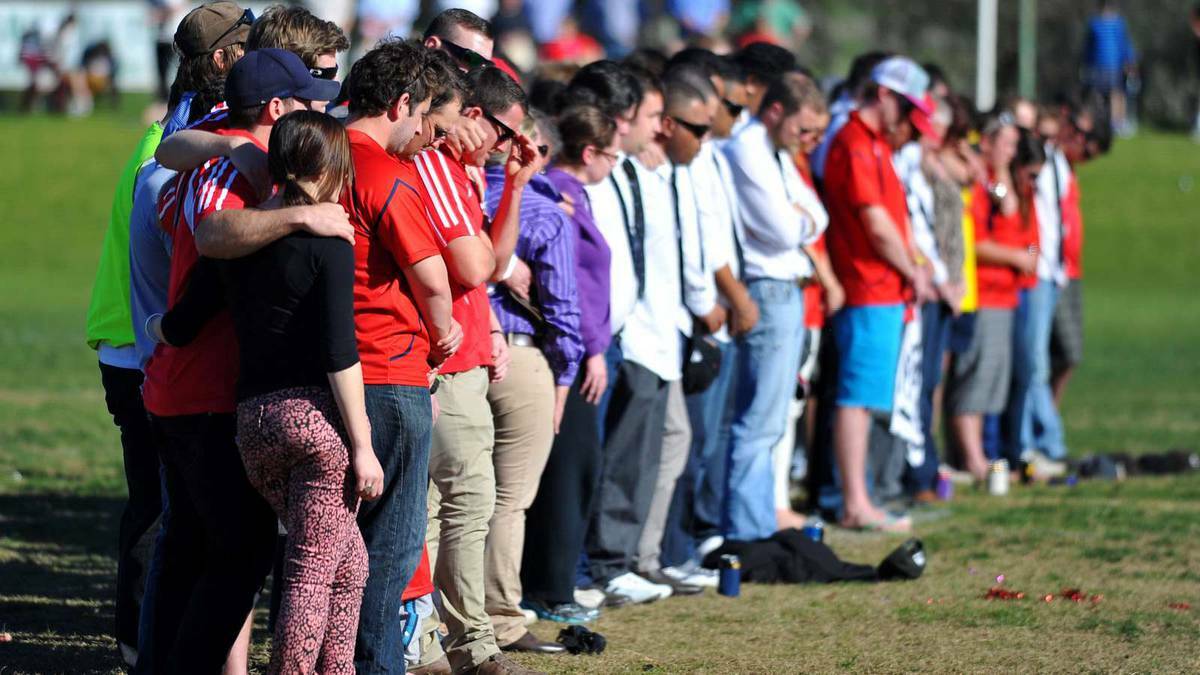 UNITED FRONT: Former friends and teammates of the late Ben Groat hold a minute’s silence before Saturday’s Southern Inland Rugby Union grand final in Wagga. 