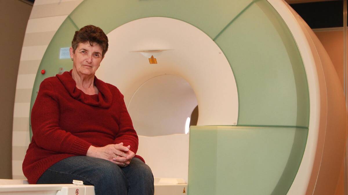 Gwen Beaton sits on the MRI scanner she desperately needs but can't afford. Picture: Anthony Stipo