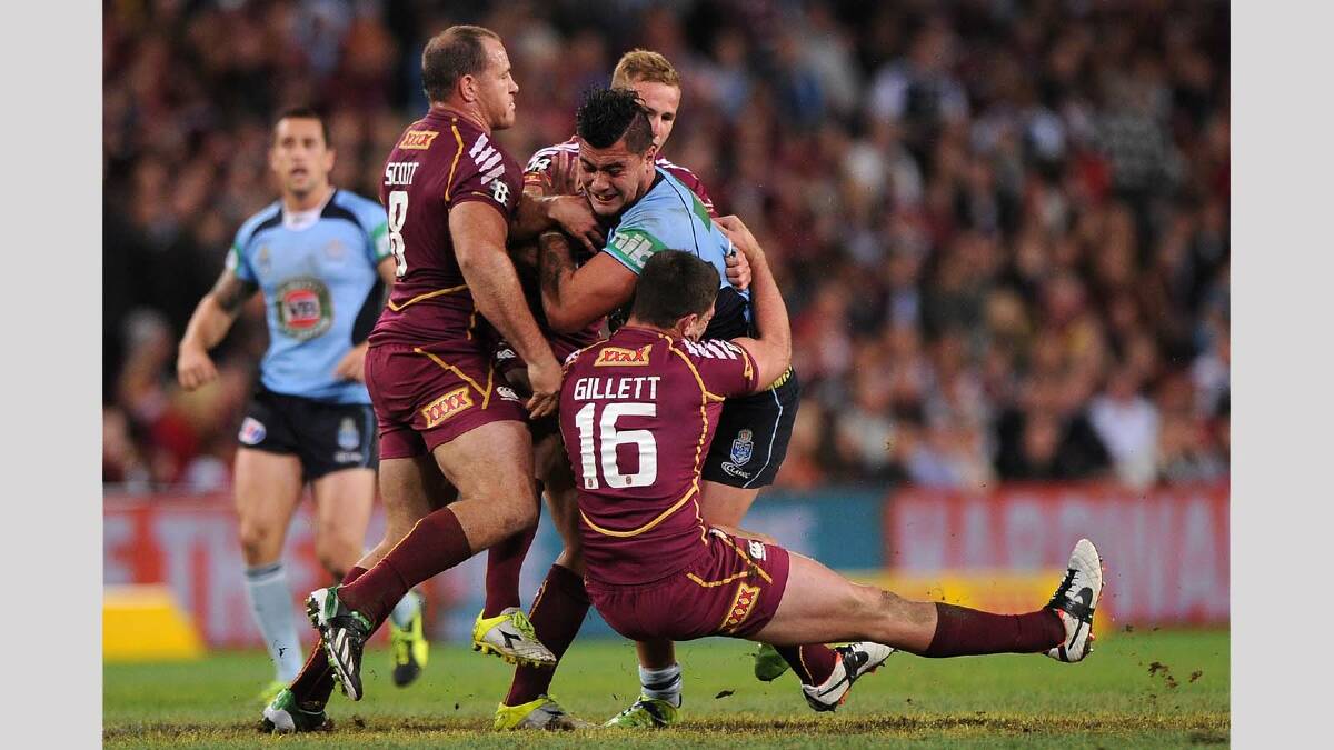 Andrew Fifita ... tackled by the Maroons during game two of the 2013 State of Origin series. Picture: Getty Images