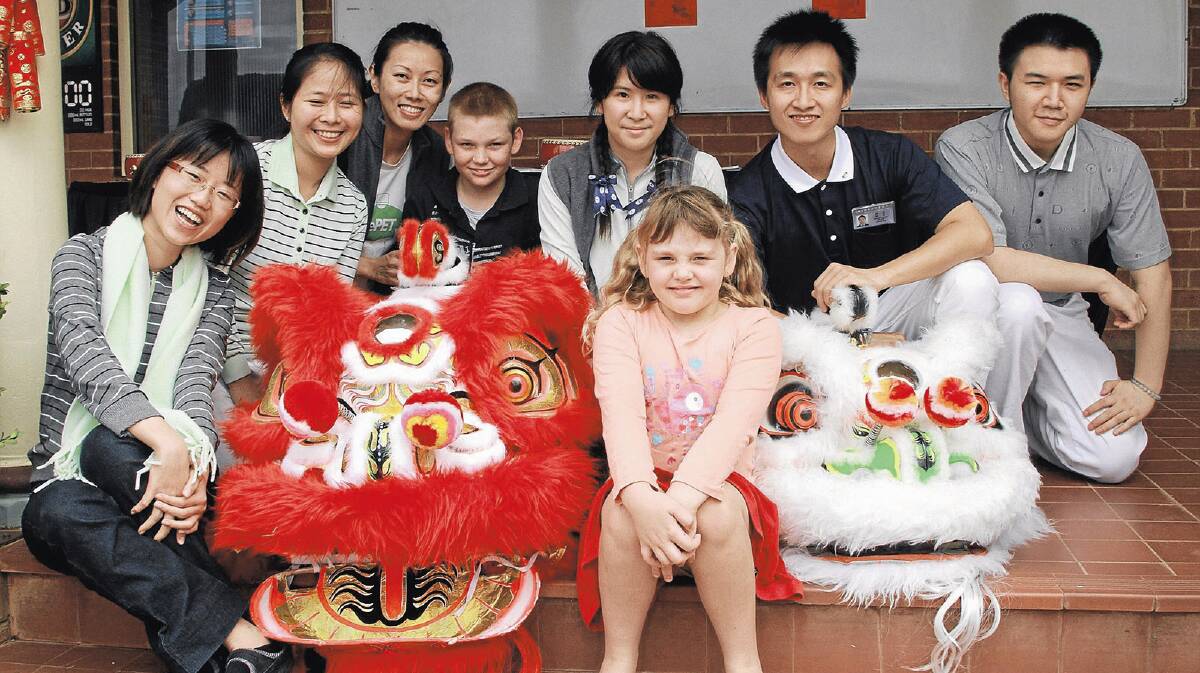  Local youngsters Kaitlin Myers, 7 (front), and Stephen Myers, 13 (back, centre) meet the Tzu Chi Foundation volunteers who brought aid to Yenda after the floods.  Zoe Yu, Shanne Yu, Esther Seah, Vivien Liang, Joseph Chen, Sham Channg and Warren Sung treated the village to Chinese New Year celebrations on Saturday.