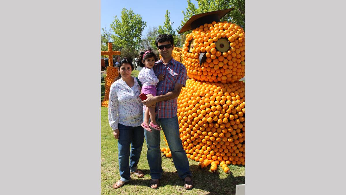 FAMILY: Hiz and Surayye Jamali with daughter Haani, 2, in front of the Griffith University of the Third Age’s sculpture.