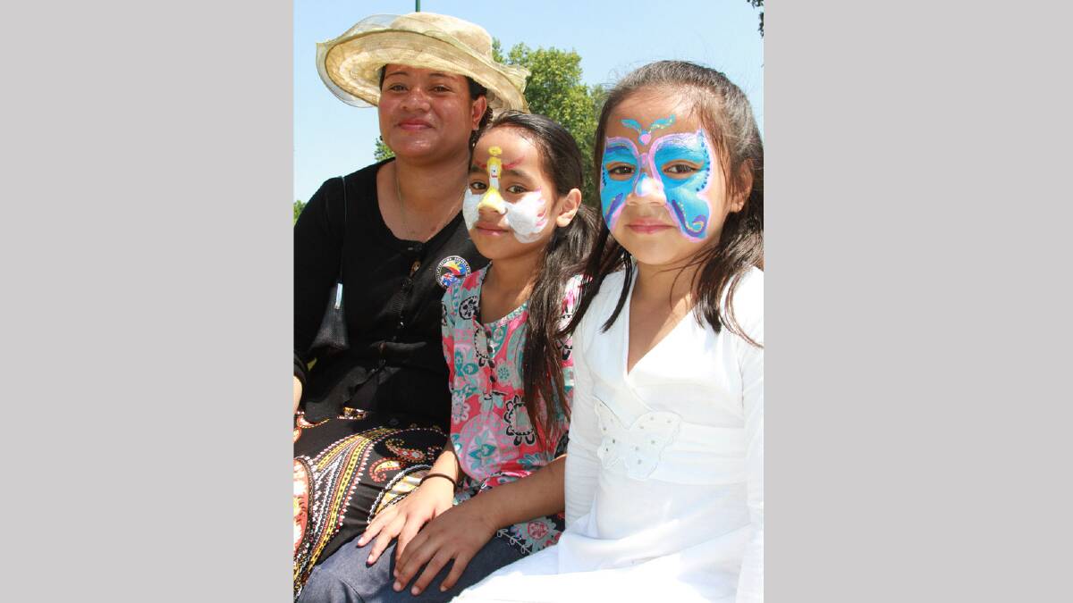 Moe Asomua with her daughters Siala, 8, and Tauala, 6, at the Multicultural Festival. Picture: Anthony Stipo