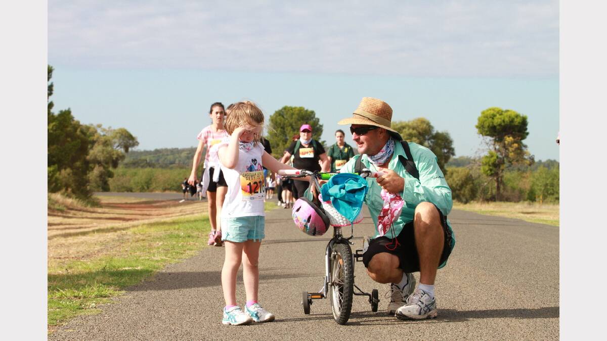 City to Lake fun run - Brian O'Sullivan tries to coax daughter Claire, 4, back onto her bike. Picture: Anthony Stipo