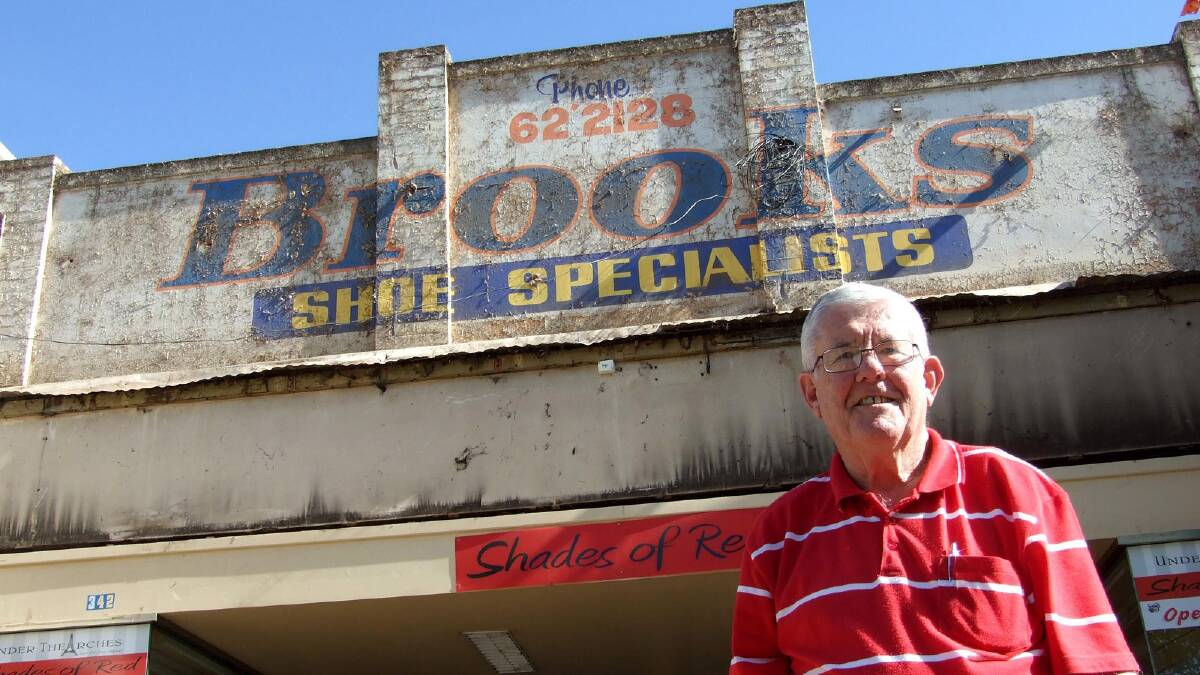 FOND MEMORIES: The old Brooks Shoe Specialists sign that was unveiled over the weekend has brought back a lot of memories for former manager Mal Ledwidge.