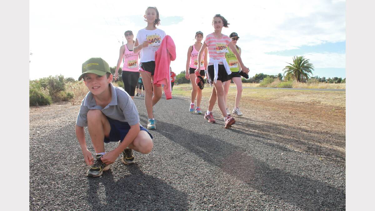 City to Lake fun run - Angus Brown, 9, stops to tie his shoelace. Picture: Anthony Stipo