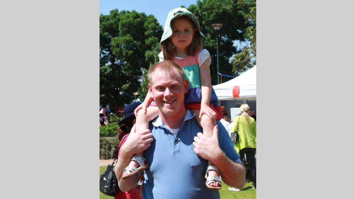 Eleanor Hayes, 3, gets a good look at the Griffith Multicultural Festival on dad Dave's shoulders. Picture: Anthony Stipo