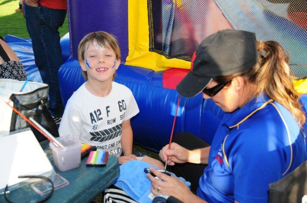 Seth Brand has his face painted at the Rotary Christmas carnival on Friday night. Picture: Bill Donaldson.