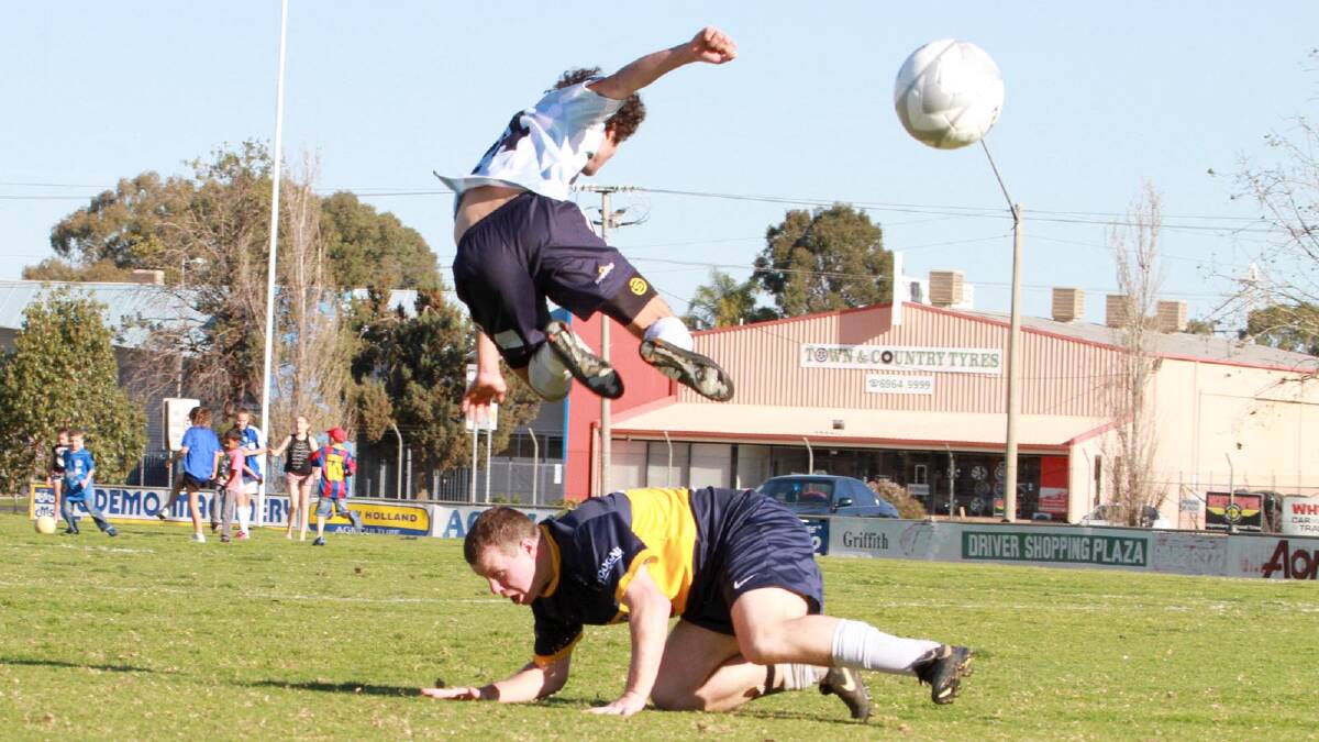 Yoogali SC's David Sinclair and Hanwood FC's Jarrod Gale in the reserve grade competition in September. Picture: Anthony Stipo