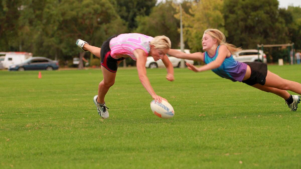 Emeri Pink Moscato's Kandice Marin and Yenda Prods Young Gunns' Daisy Tyrrell in the touch football grand final. Picture: Anthony Stipo