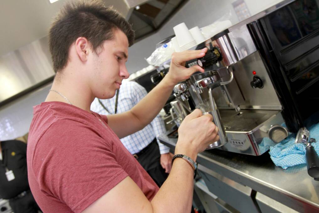 Sean Close and Krystelle Demeyer, both 18, practice their new coffee-making skills.