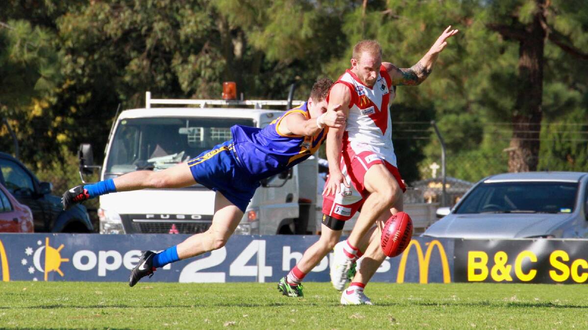Guy Orton gets one away for the Griffith Swans. Picture: Anthony Stipo