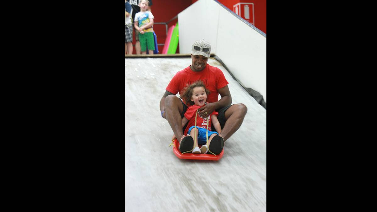 Two-year-old Kameli Loaloadravu with dad Apisal enjoy the ice rink at Griffith Central. Picture: Anthony Stipo