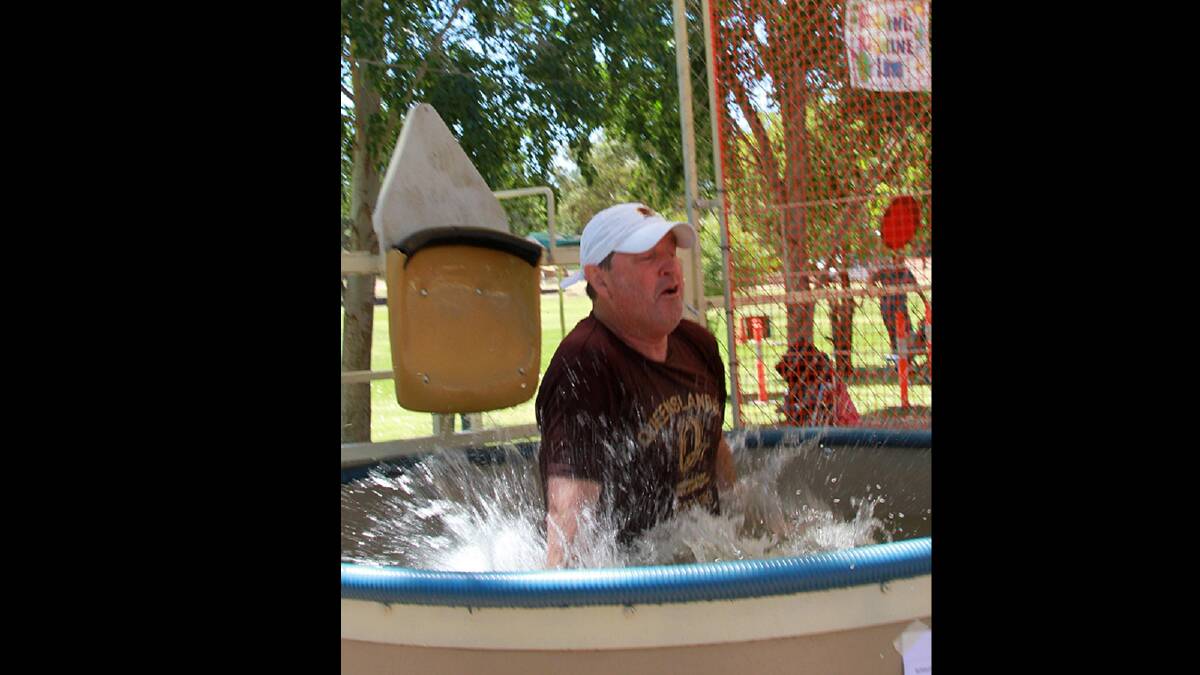 St Pats principal David Adams-Jones gets dunked at the parish fete. Picture: Anthony Stipo