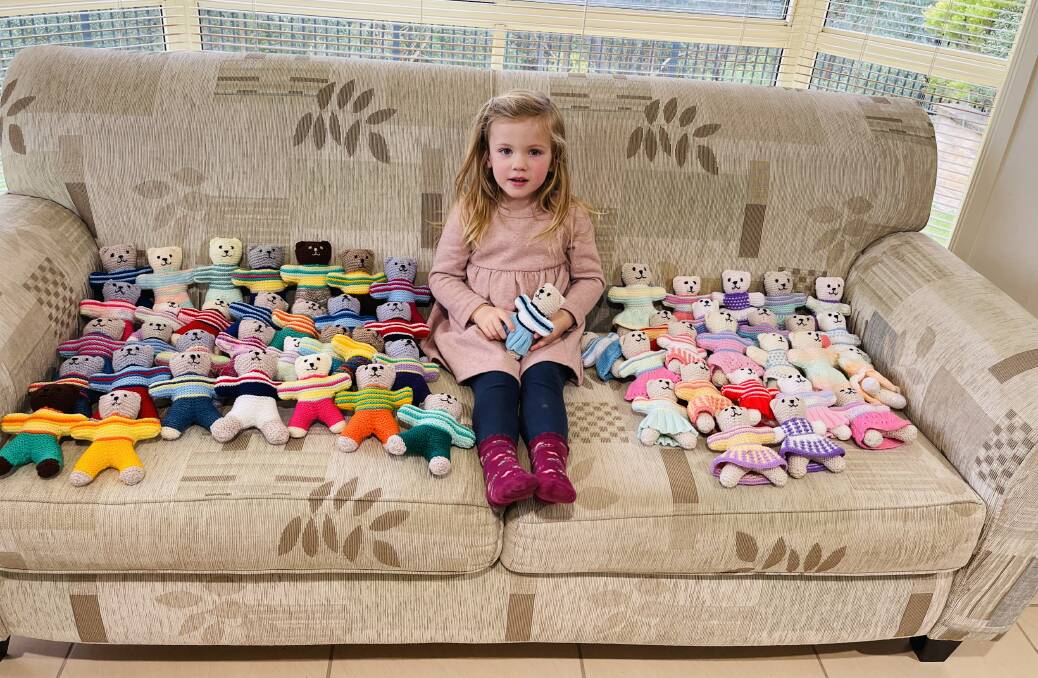 TEDDY BEAR PICNIC: Elizabeth Sinclair, granddaughter of Anne Sinclair and great-granddaughter of Dorothea Bond, surrounded by the teddy bears her family knitted. PHOTO: Contributed