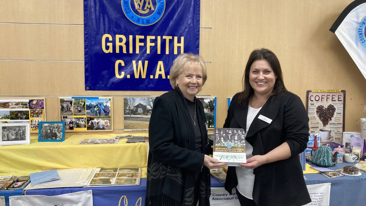 Griffith CWA President Cheryll Steele hands over the book 'The Women who Changed Country Australia' to library teams leader Rina Cannon. PHOTO: Cai Holroyd