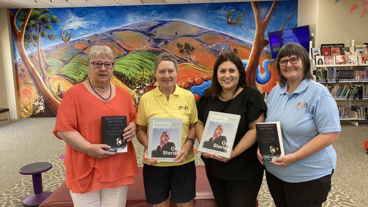 BOOK 'EM: Sheila Brady, Liz Humphreys, Rina Cannon and Lyn Cathcart met at the library to give and receive the set of books. PHOTO: Cai Holroyd