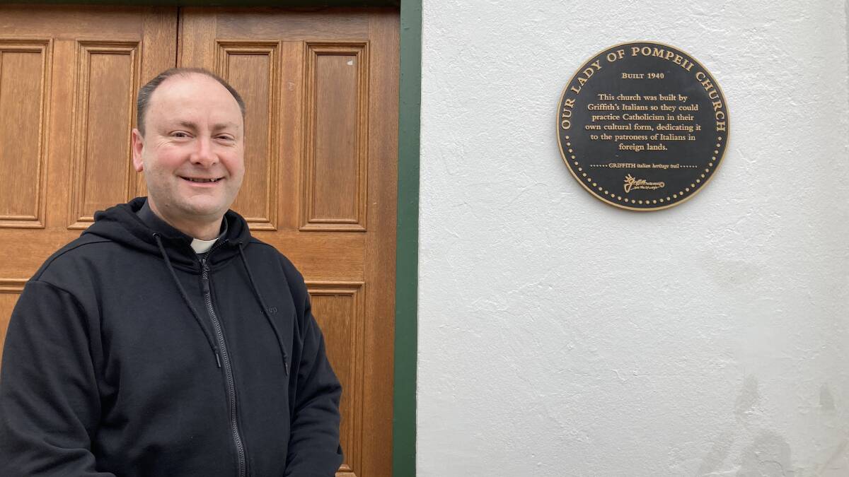 GOD HOUSE: Reverend Peter Stojanovic next to the brand-new Italian heritage path plaque that adorns the church. PHOTO: Cai Holroyd