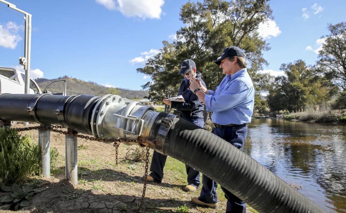PIPE DOWN: The National Resources Access Regulator checking the pipes for proper metering. PHOTO: Contributed