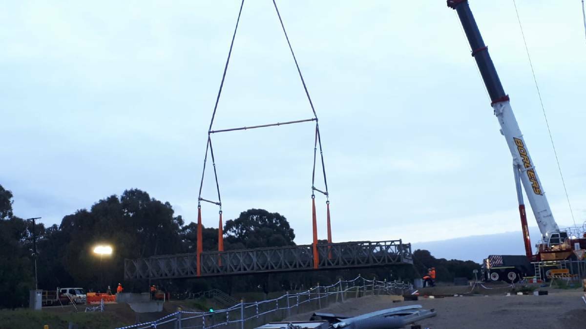 EASY DOES IT: The temporary bridge was lowered by crane into the gap before being attached to the road. PHOTO: File