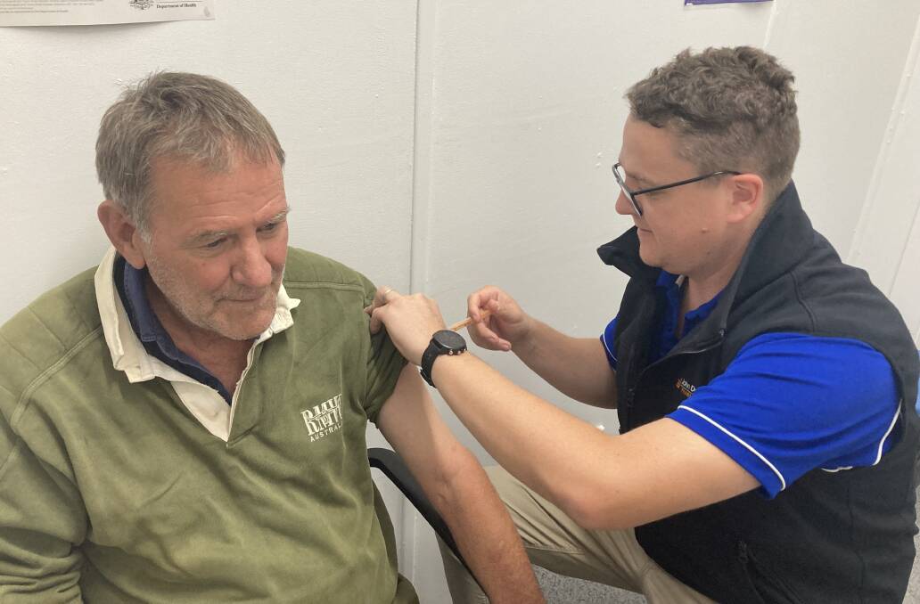 VACCINATED: Pharmacist Sean Dodd with Lex Vearing, receiving a flu shot. PHOTO: Cai Holroyd