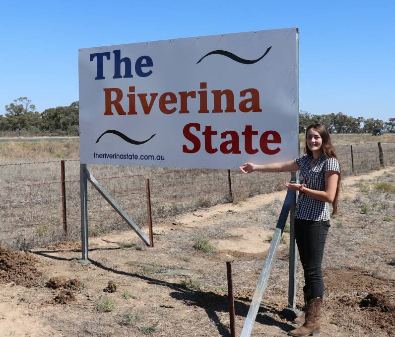 Jacinta Cooper presenting the new sign for the Riverina State Group. Photo: Provided.