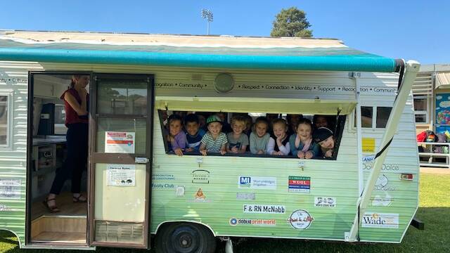 SERVICE WITH SMILES: A year 1 class toured the Carevan to learn about how it services the community. PHOTO: Contributed