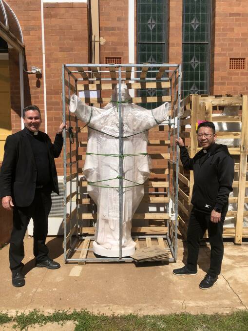 PLEASED: Reverend Andrew Grace and Reverend Paul Lu with the new statue. PHOTO: Contributed
