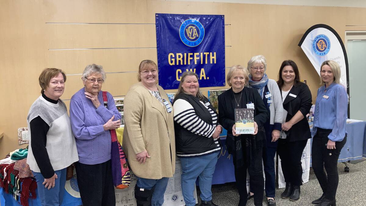 GIFT: Lesley Higgins, Coralie Gandy, Karen Byrne, Ann Scroop, Cheryll Steele and Kerrie Brill from the CWA. On the right, Rina Cannon and Sharmaine Delgado from Griffith City Library. PHOTO: Cai Holroyd