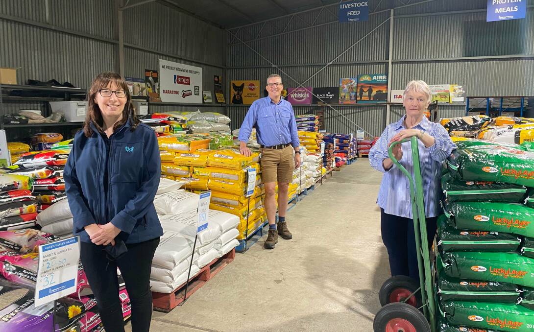 MILESTONE: Cheryl Wood and Richard West pose inside the back warehouse at Griffith Feed and Grain alongside Phyliss Dart, who started the business in 1996. PHOTO: Lizzie Gracie