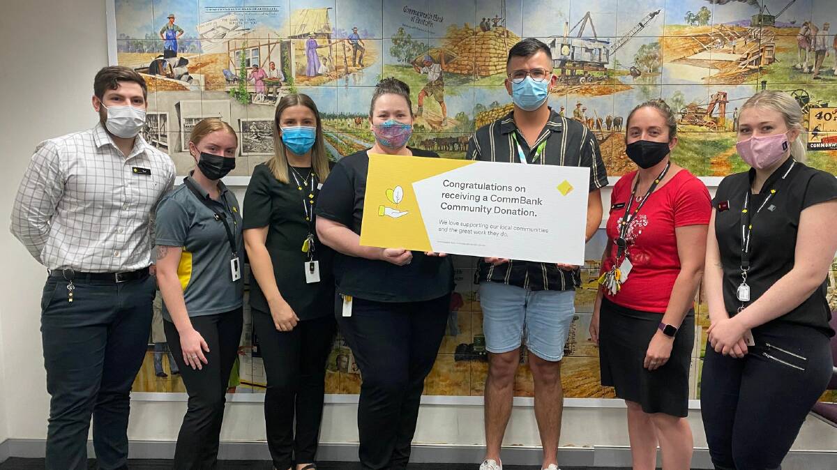 A WELCOME DONATION: Griffith Branch staff at Commonwealth Bank present a novelty cheque for $500 to Headspace Griffith staff member Dylan Oliver. PHOTO: Lizzie Gracie