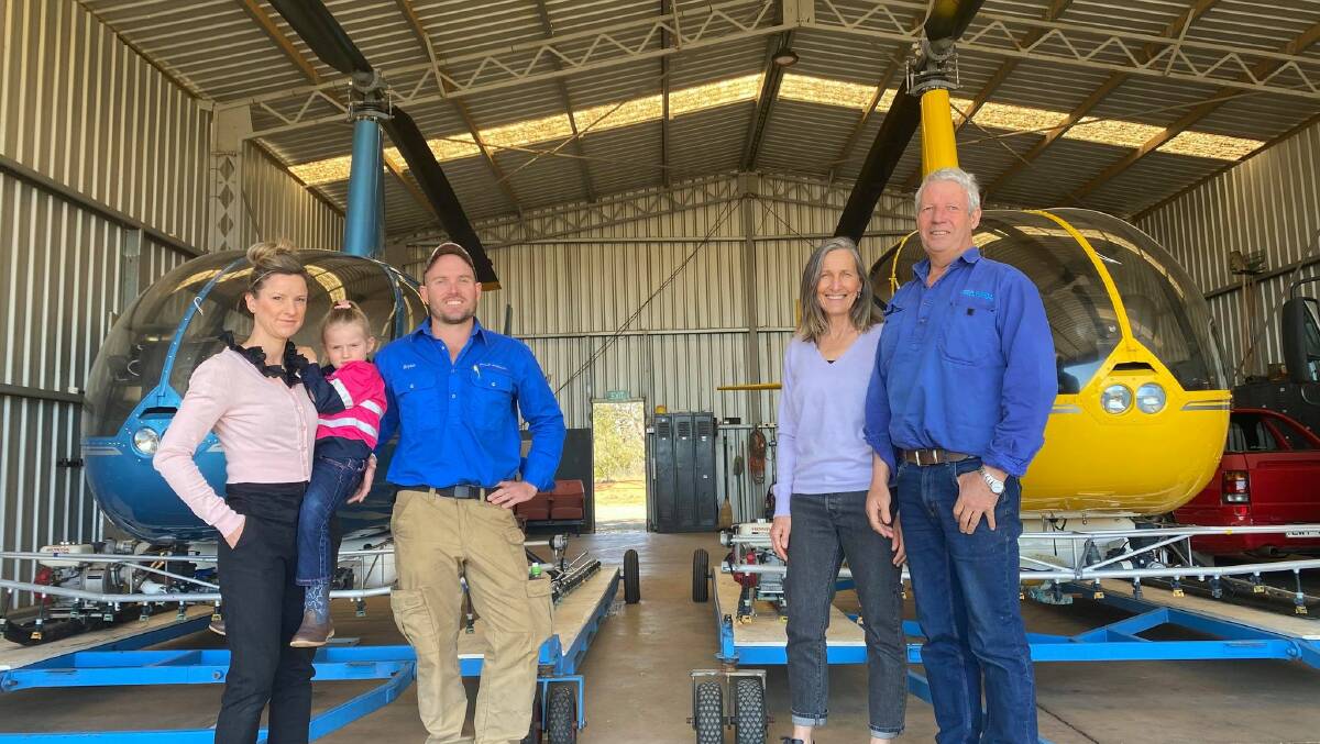 A NEW ERA: Bryce, Amanda and Skyla Nietvelt alongside Gerry and Sally Wilcox and a fleet of Robinson R44 Helicopters. PHOTO: Lizzie Gracie