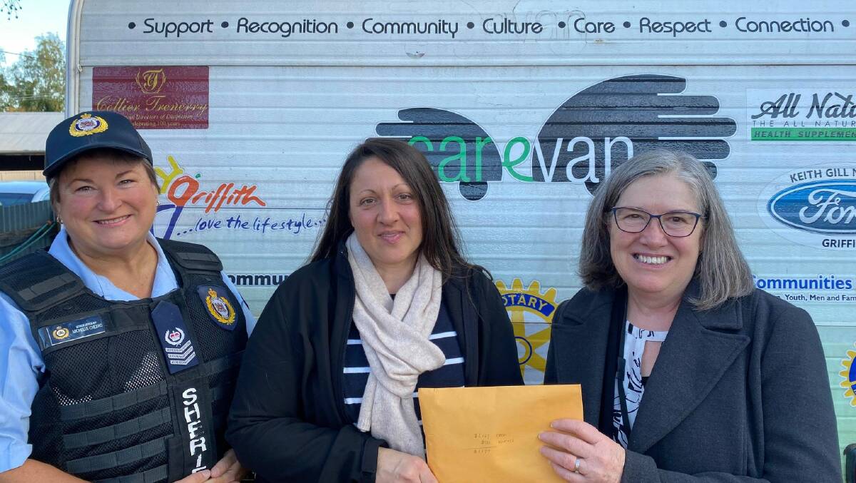 GENEROUS DONATION: Senior Sergeant Michelle Cheers (left) and Registrar Virginia Scanlon (right) present Carevan Coordinator Janice Sartor with the funds raised by the Griffith Courthouse. PHOTO: Elizabeth Gracie