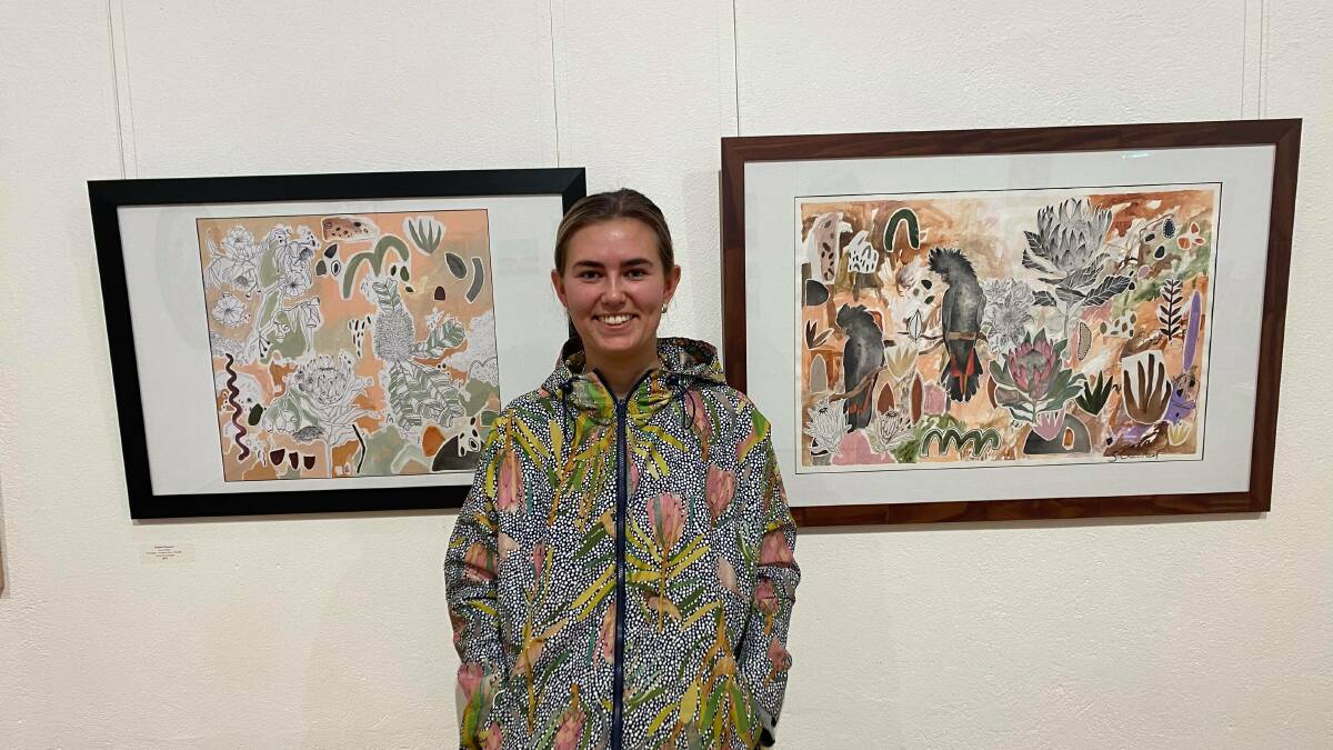 NATURE DEPICTED IN ART: Coleambally artist Sophie Chauncey with her two of her works displayed in the exhibition PHOTO: Lizzie Gracie