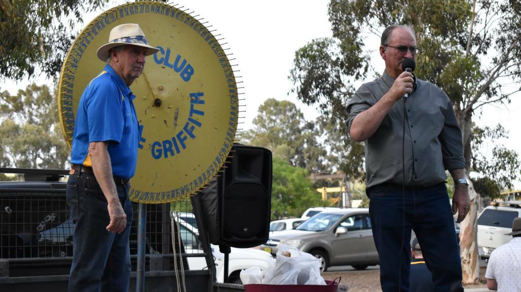SPIN THE WHEEL: Griffith Rotary Club members auction off yummy Christmas hams and a variety of other prizes in 2019, the last time the event was held. PHOTO: Shaun Paterson
